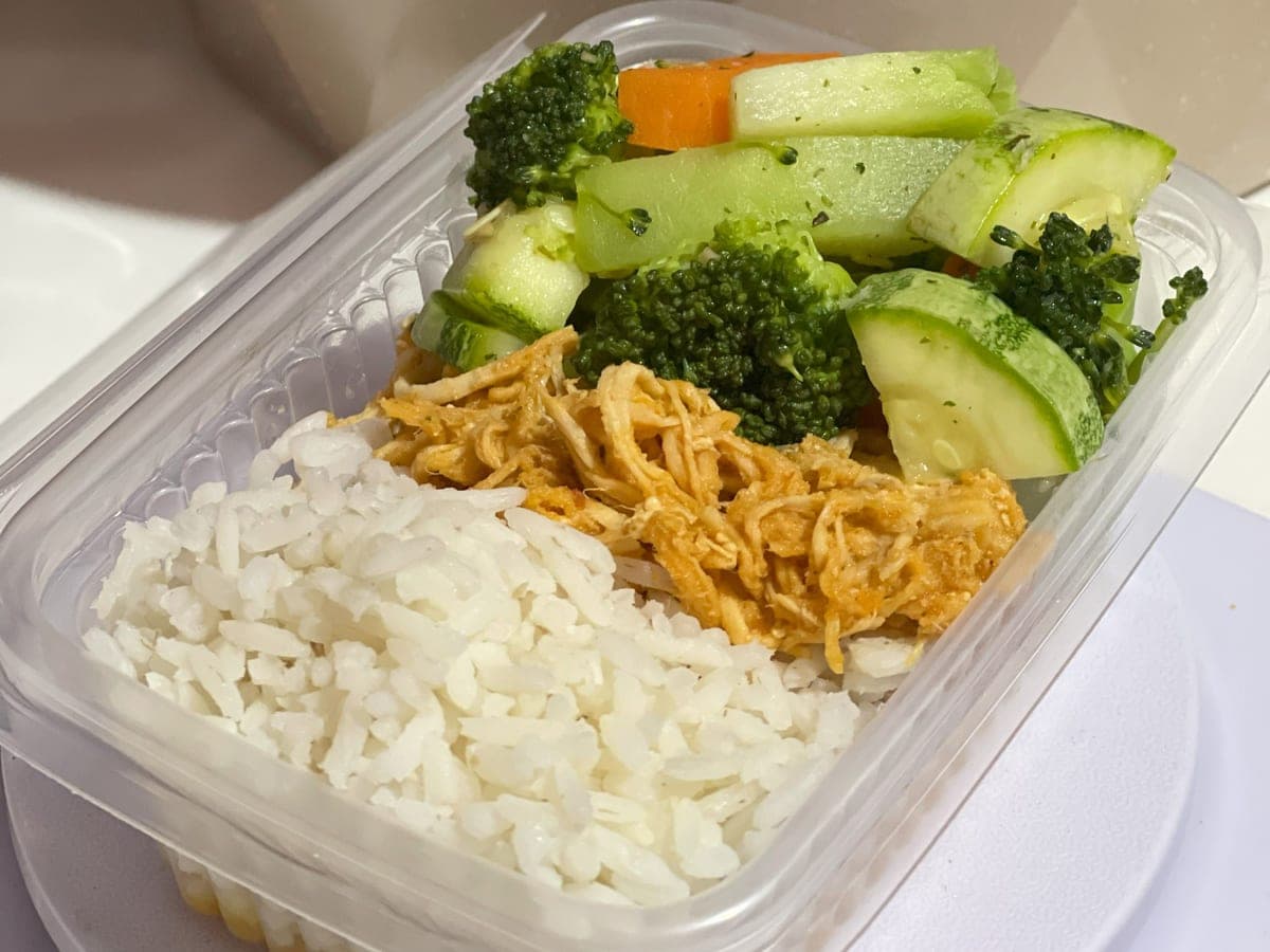 Illustrative stock photo: a meal prep box with rice, shredded chicken and mixed vegetables